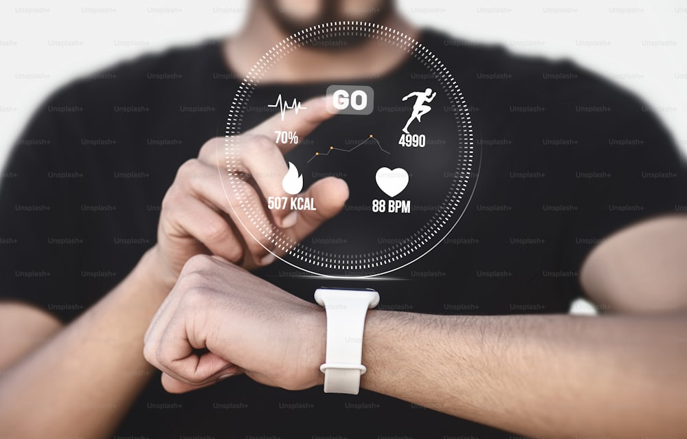 a man holding a smart watch in his hand