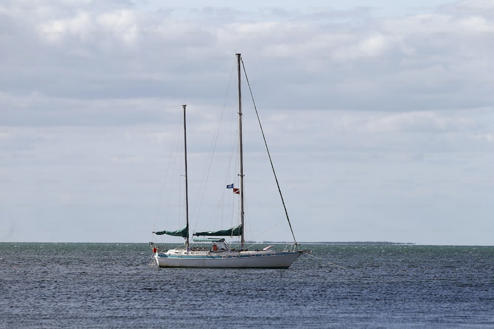 a sailboat in the middle of a body of water