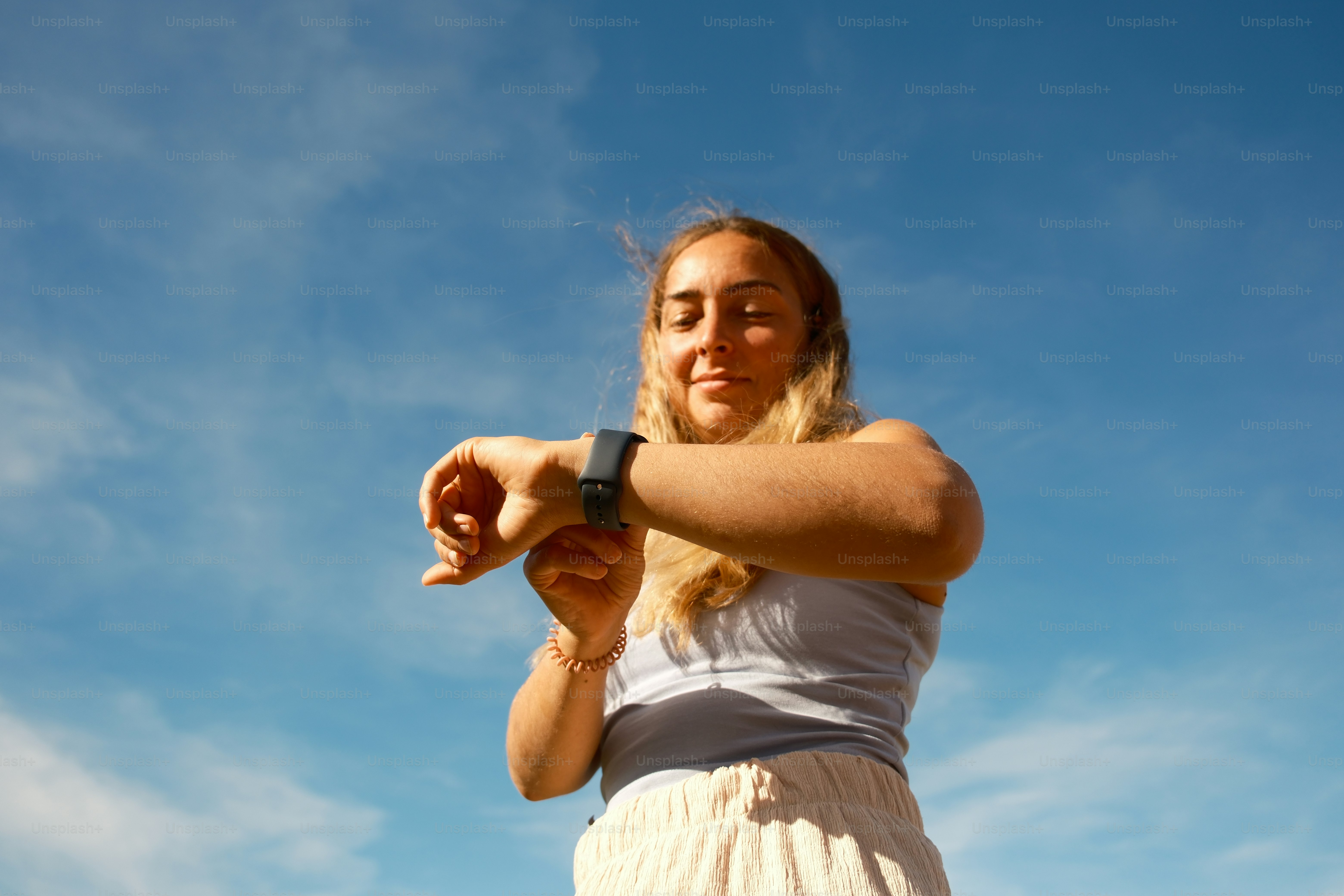 a woman in a white dress is flying a kite
