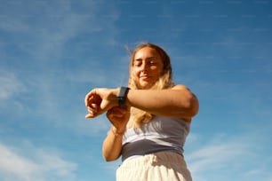 a woman in a white dress is flying a kite