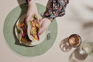 a person holding a plate with food on it