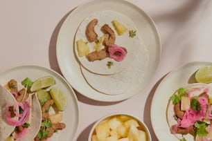 a table topped with three plates of food