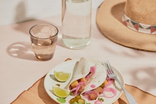 a plate of food on a table next to a glass of water