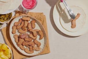 a table with plates of food and utensils