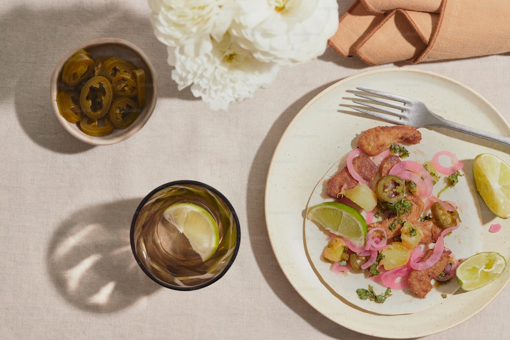 a white plate topped with food next to a glass of wine