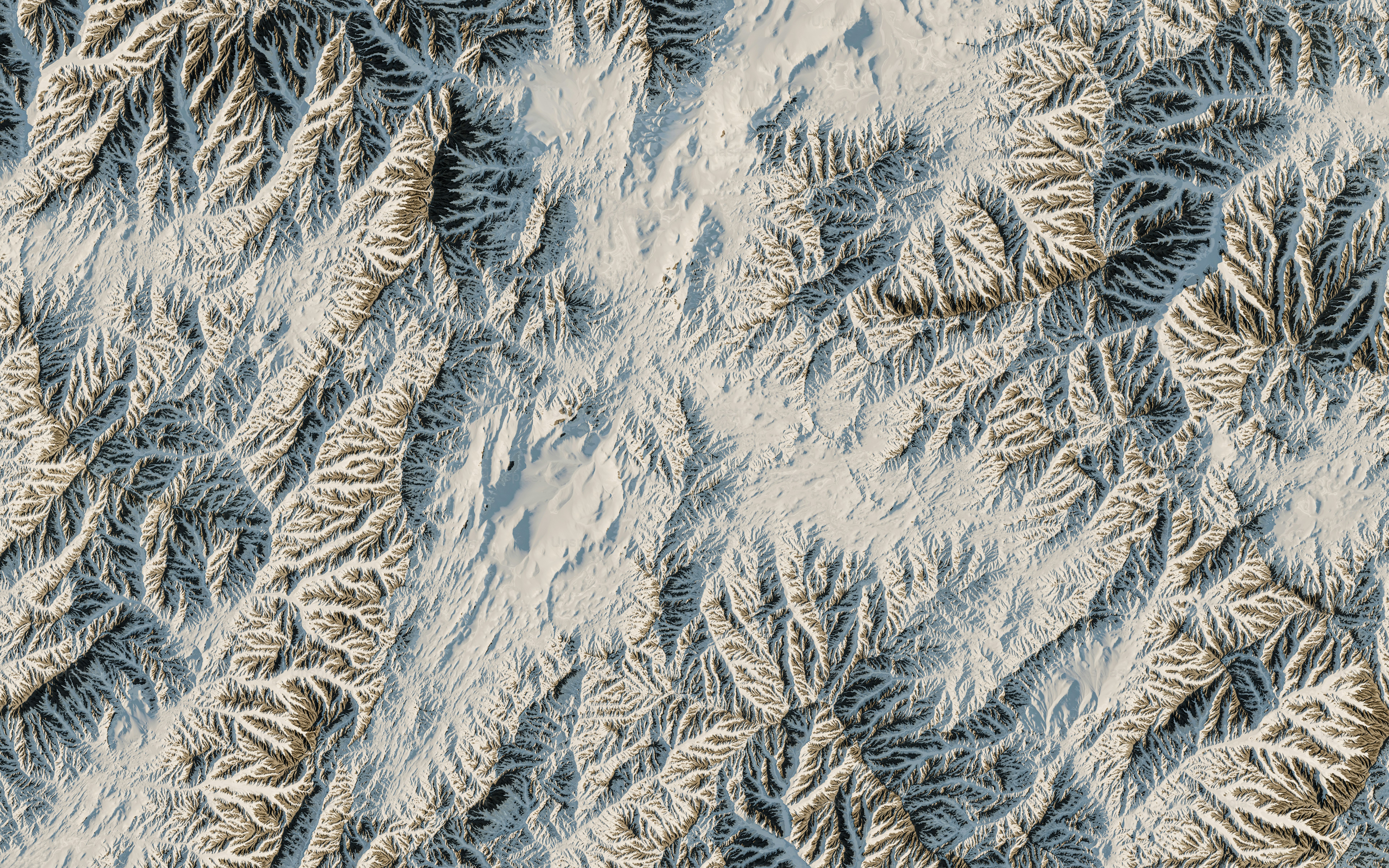 an aerial view of a snow covered mountain range