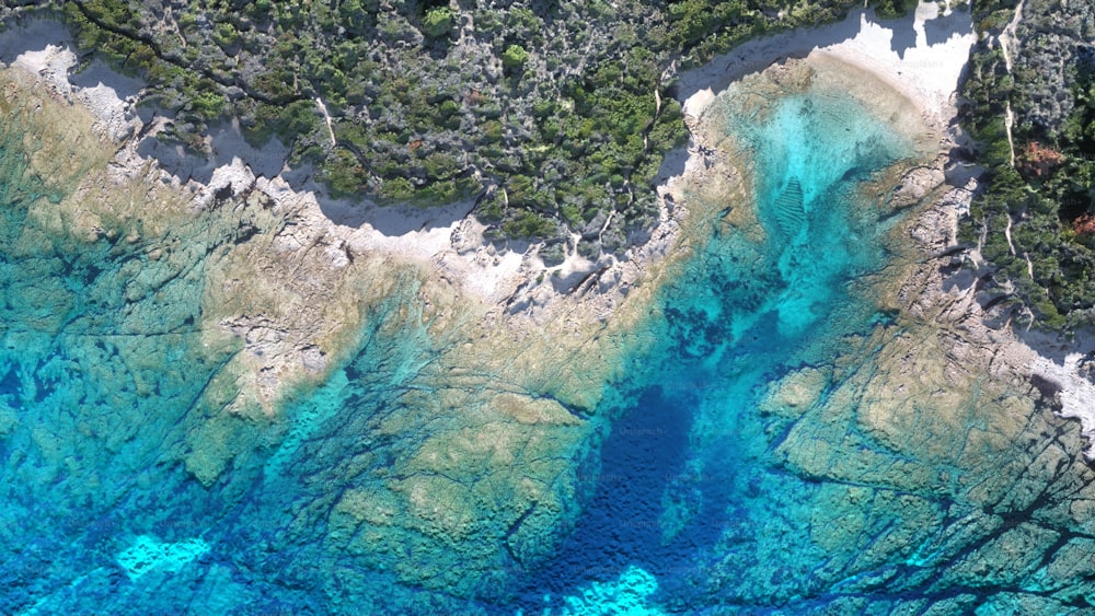 an aerial view of a body of water surrounded by trees