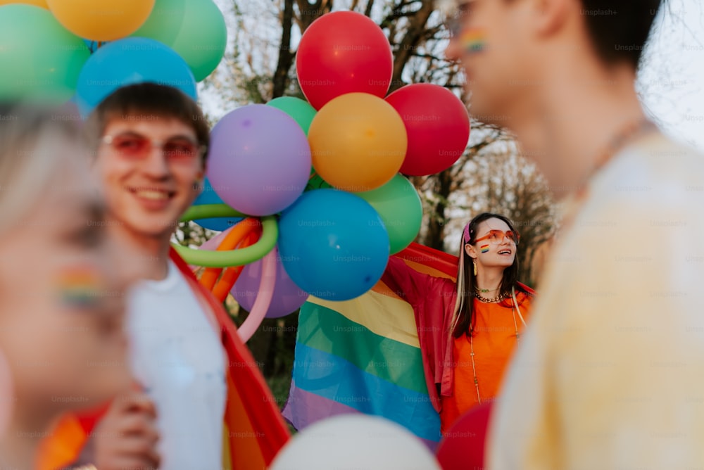 a group of people standing around each other with balloons