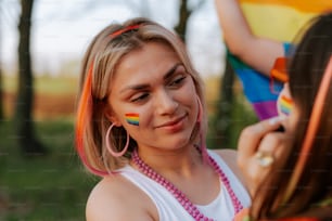 a girl with a rainbow painted on her face
