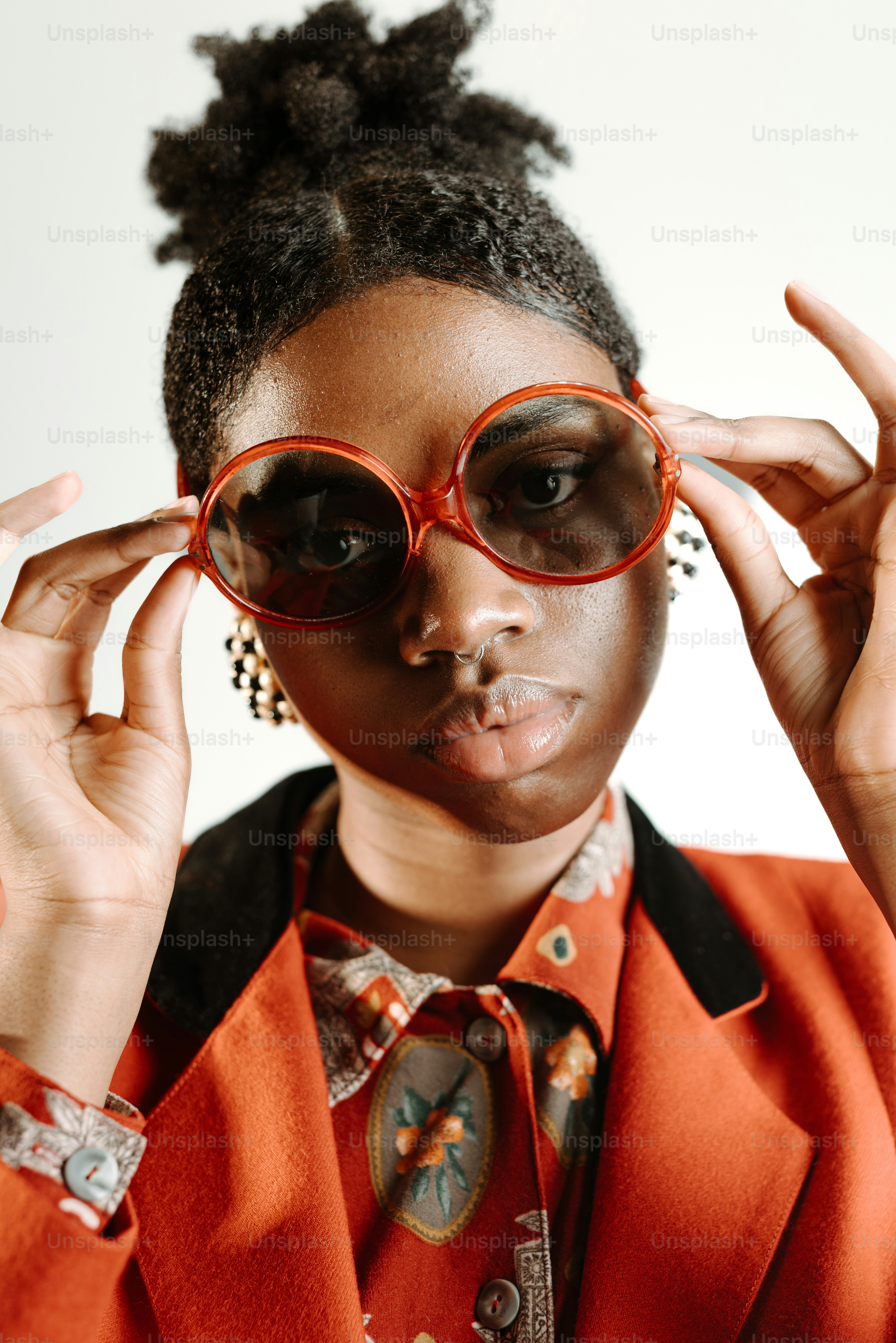 a woman wearing red glasses and a red jacket