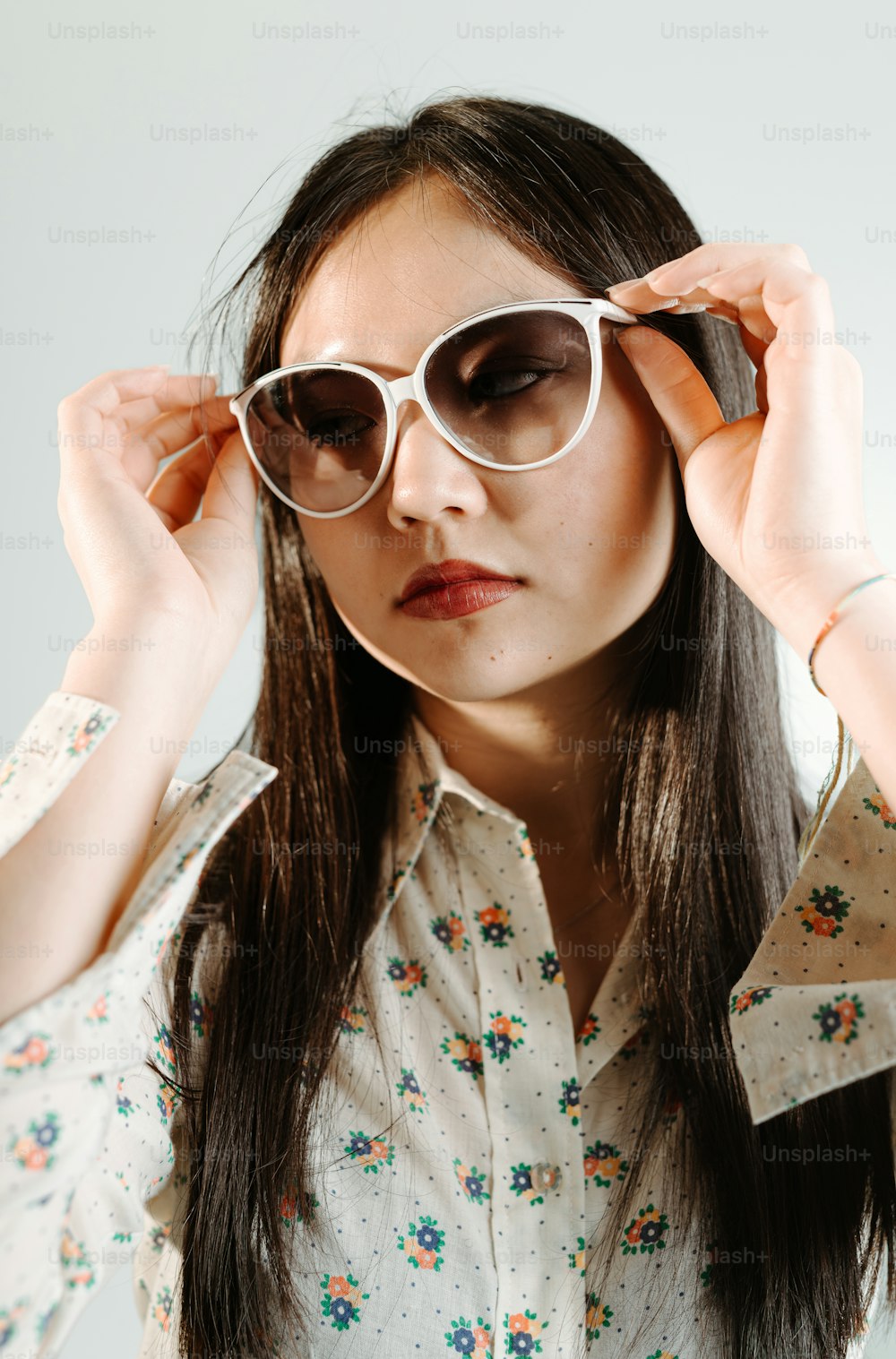 a woman wearing a pair of white sunglasses