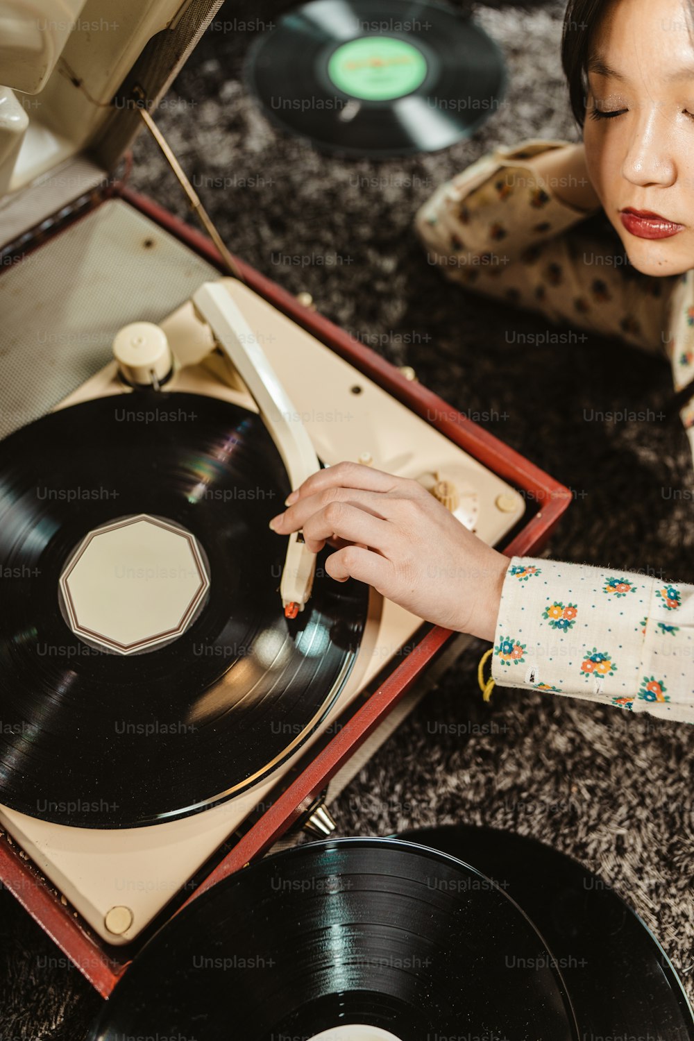 a woman is looking at a record player