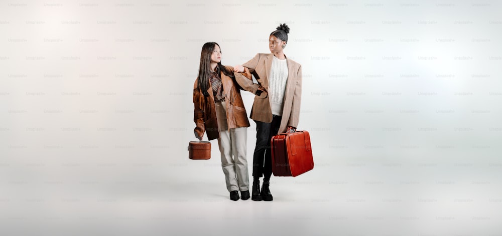 a man and a woman are holding suitcases