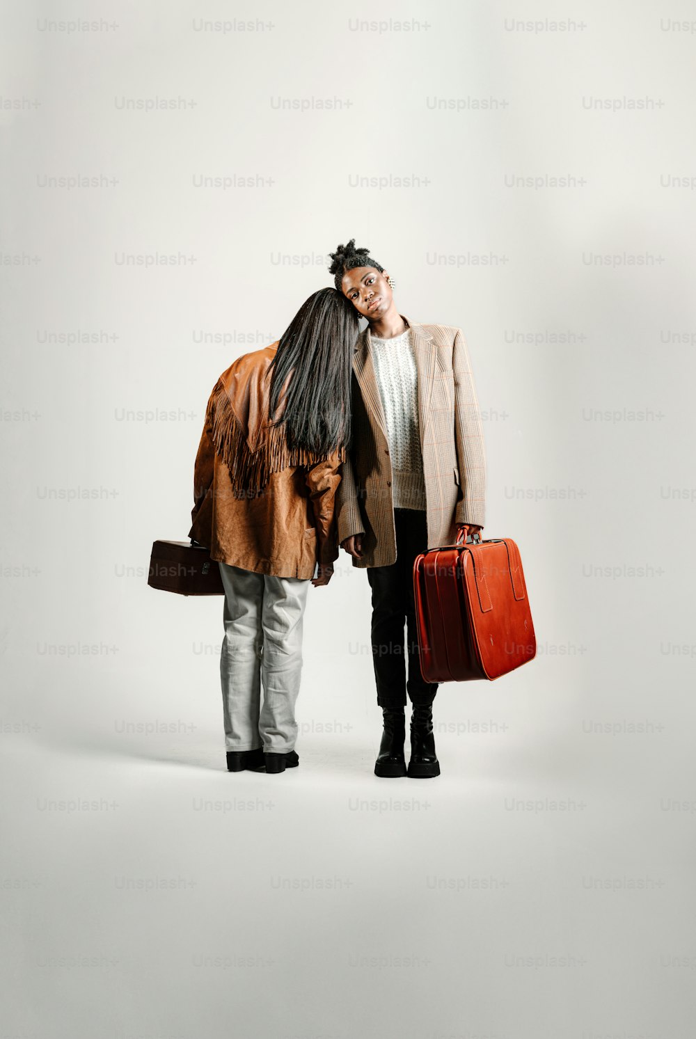 a man and a woman standing next to each other with luggage