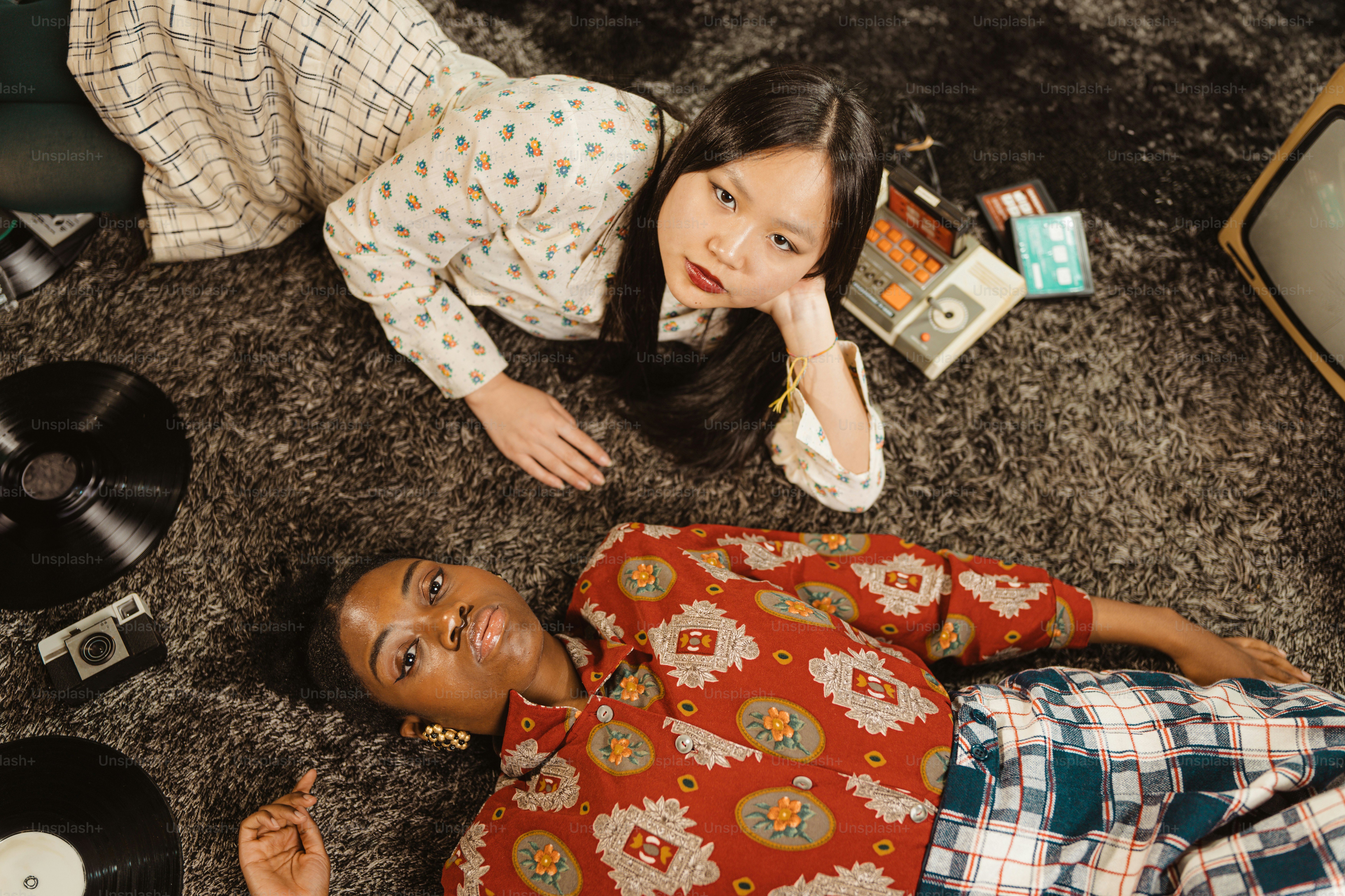 a couple of people laying on the ground next to each other