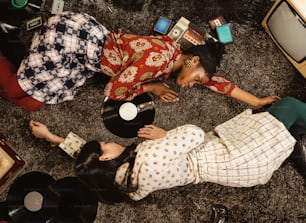 a couple of women laying on the floor next to each other
