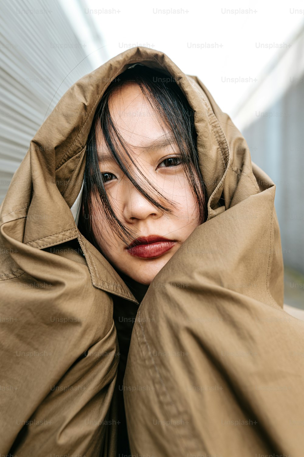 a woman in a brown coat with a red lipstick