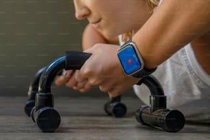 a young girl is doing push ups with a smart watch