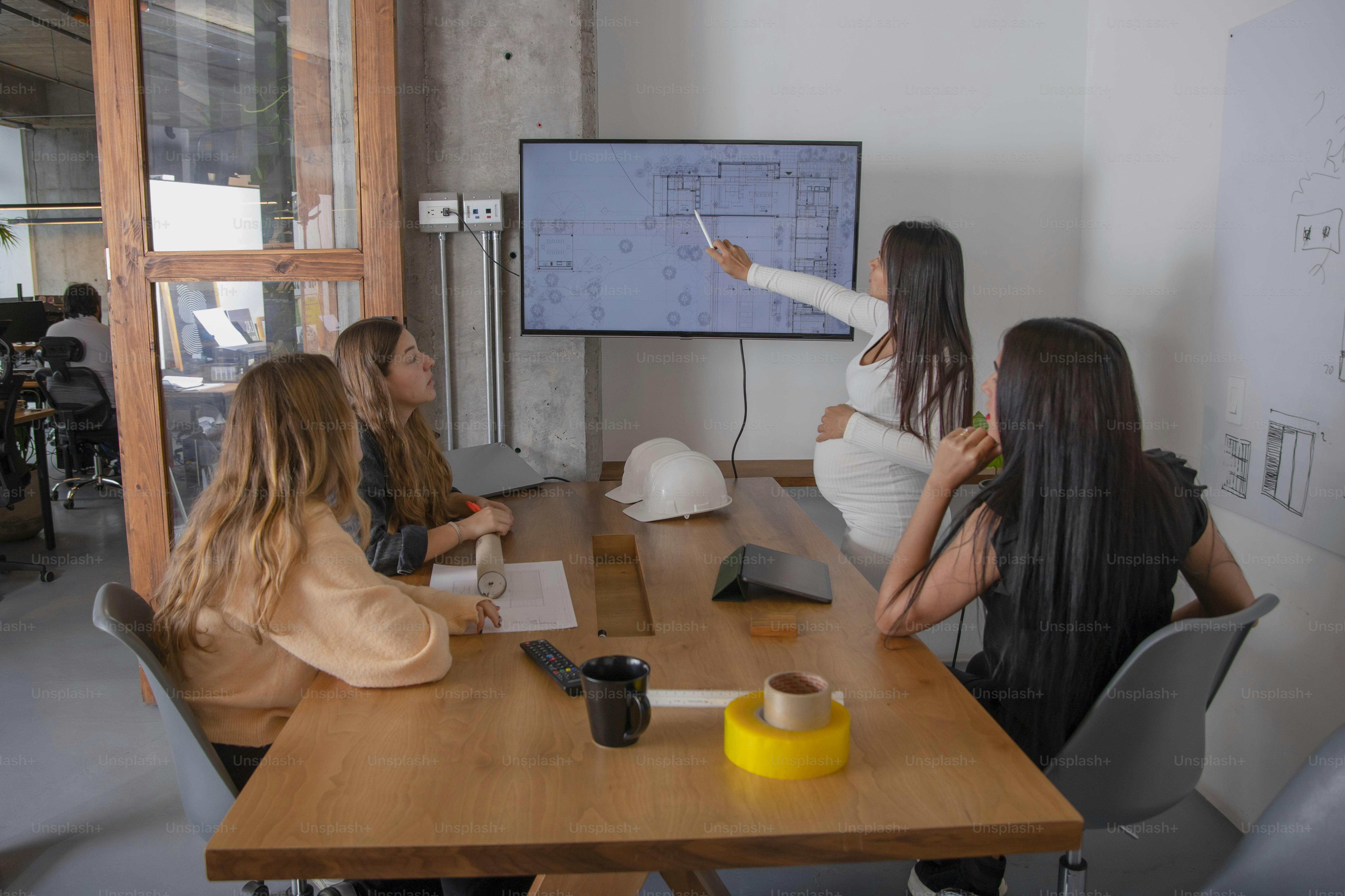 a group of women sitting around a wooden table