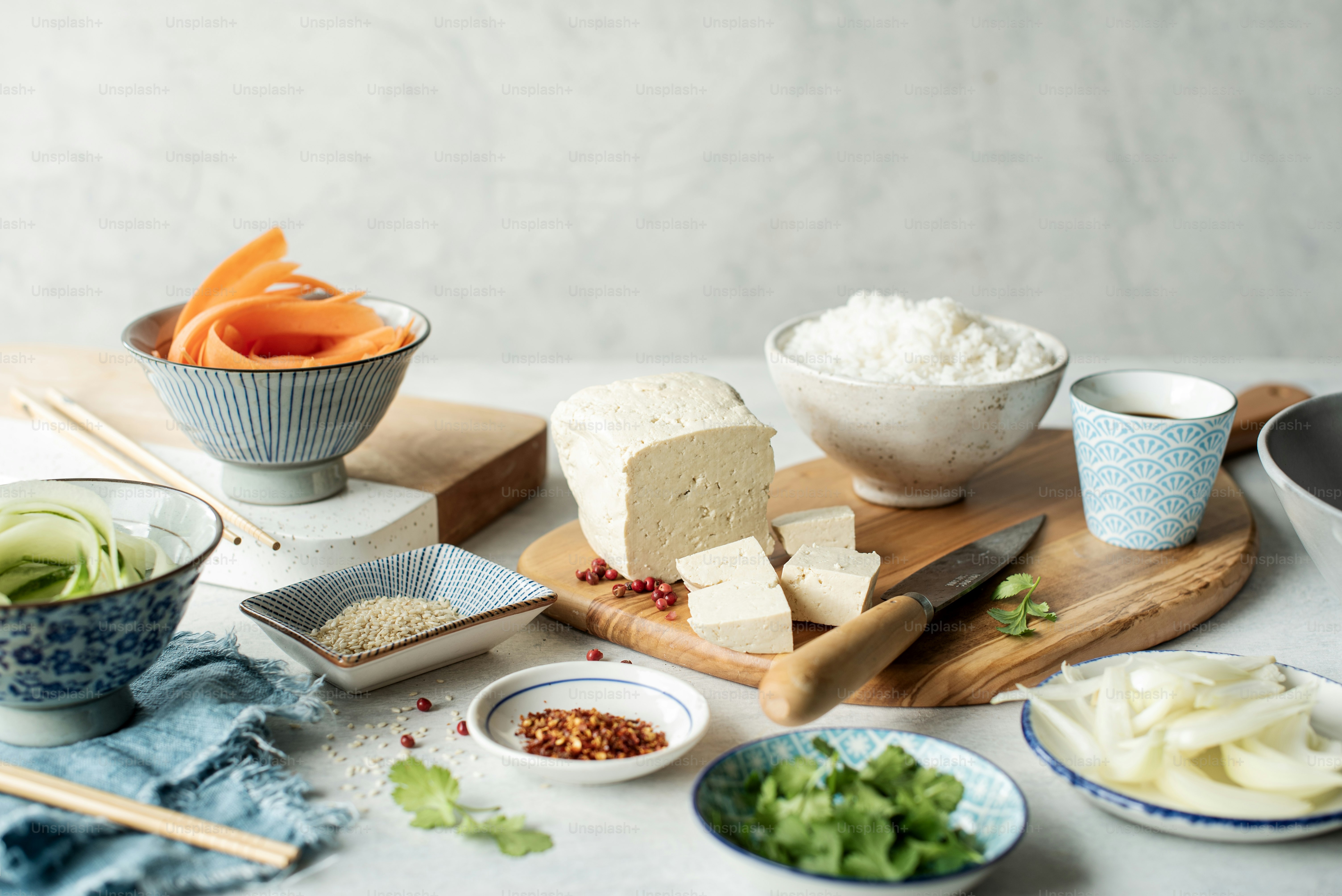 a table topped with bowls of food and bowls of rice