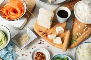 a wooden cutting board topped with lots of food