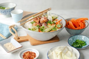 a table topped with bowls of food and chopsticks