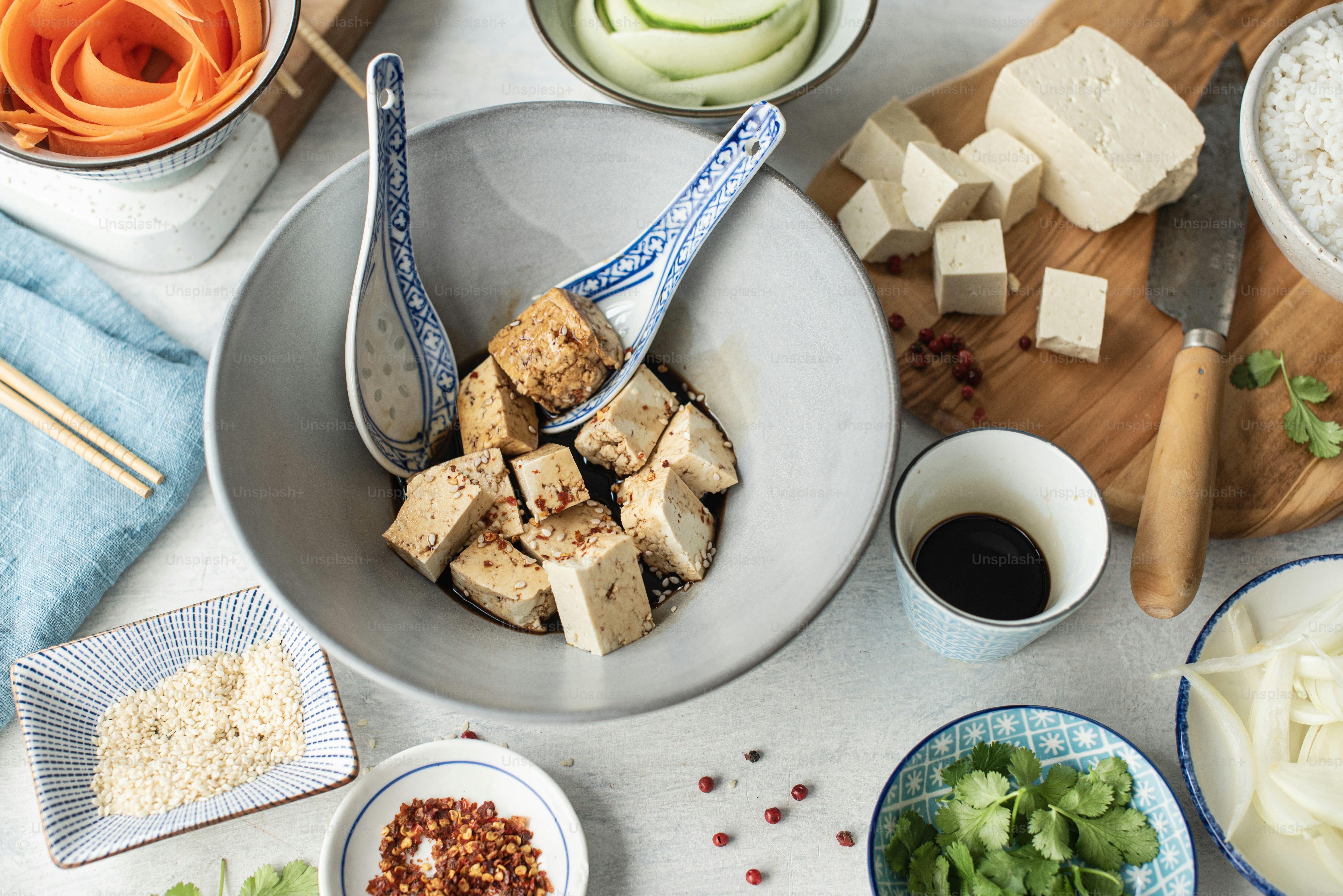 a table topped with bowls filled with food