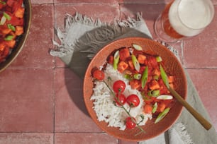 a bowl of food and a glass of milk on a table