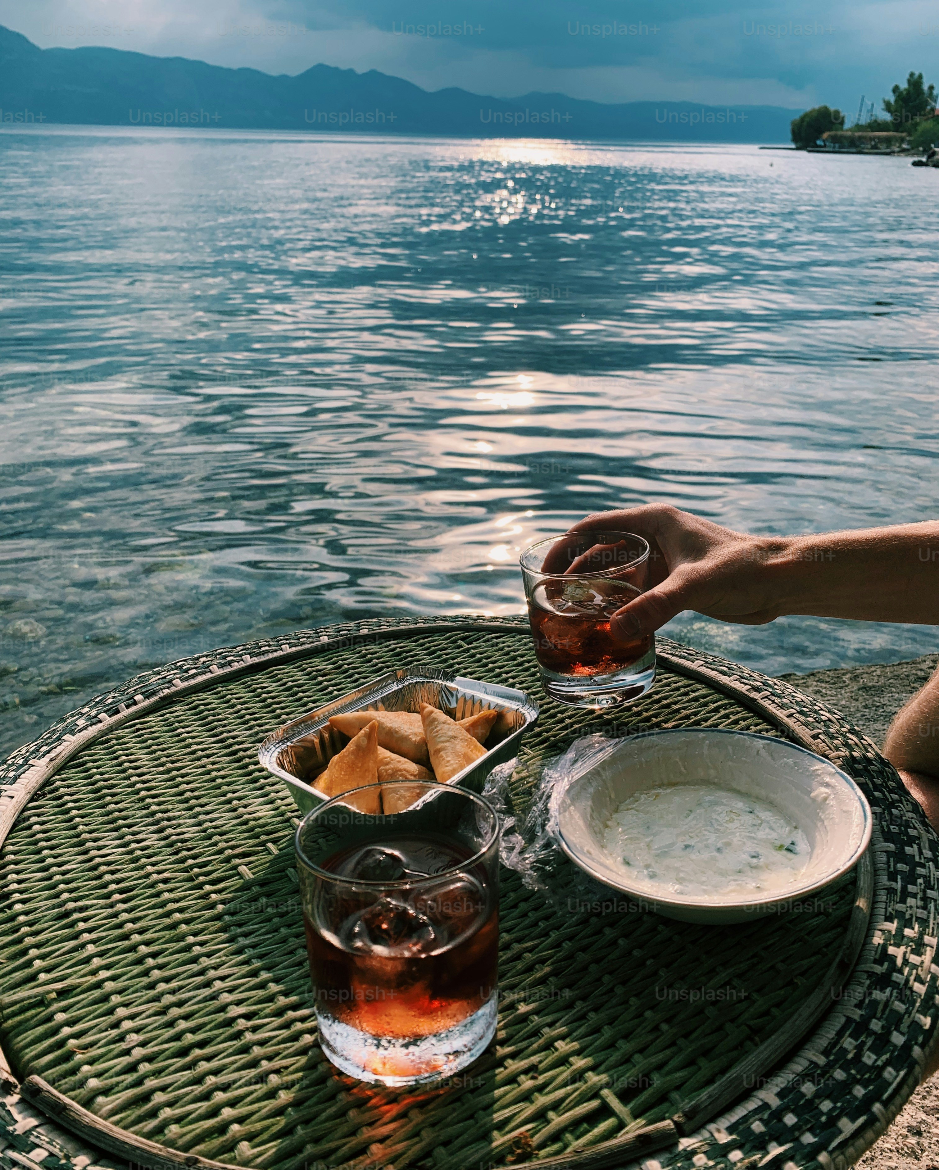 a person sitting at a table with a bowl of food
