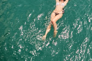 a woman in a bikini swimming in the ocean