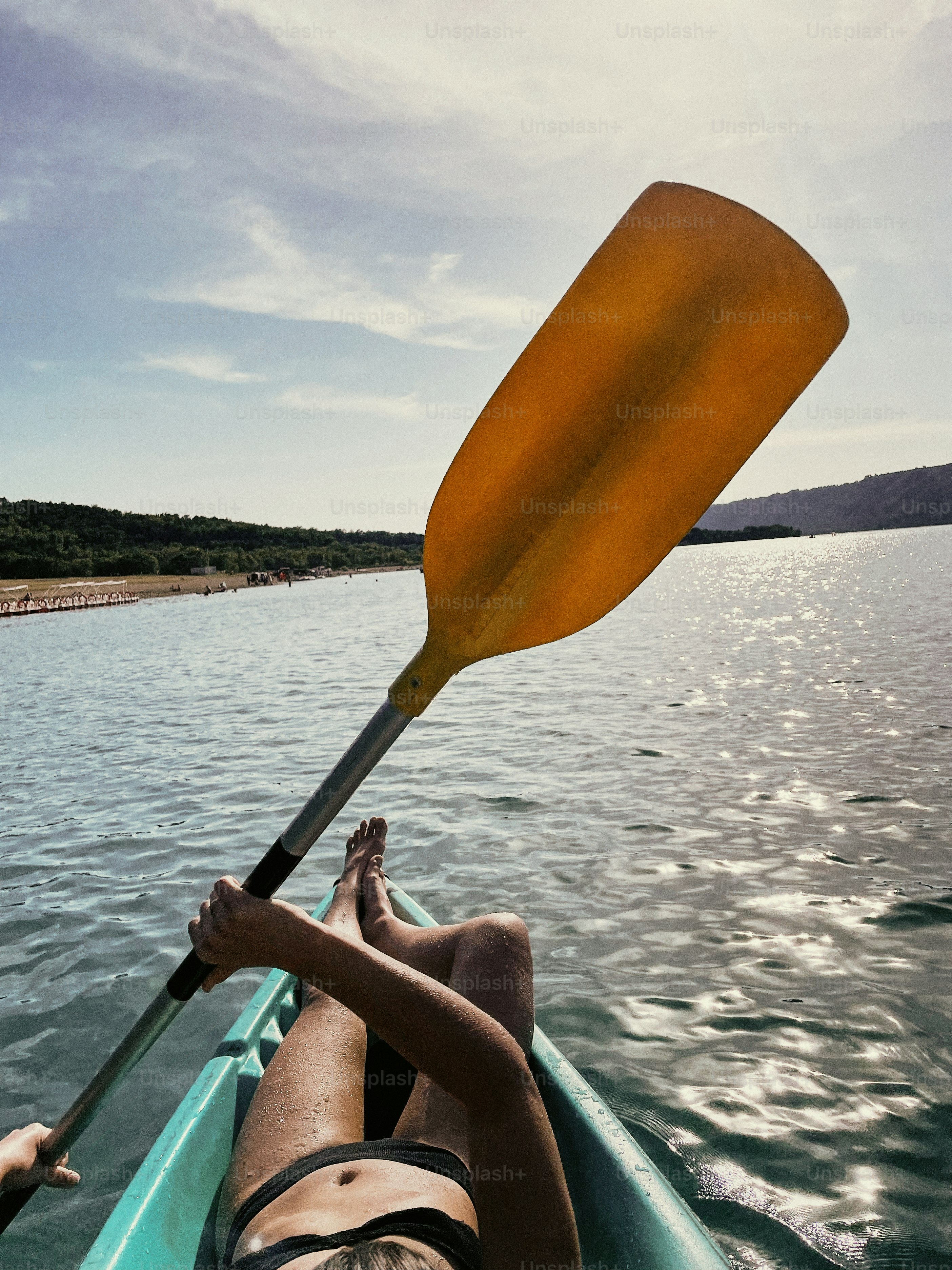 a person in a kayak paddling on the water