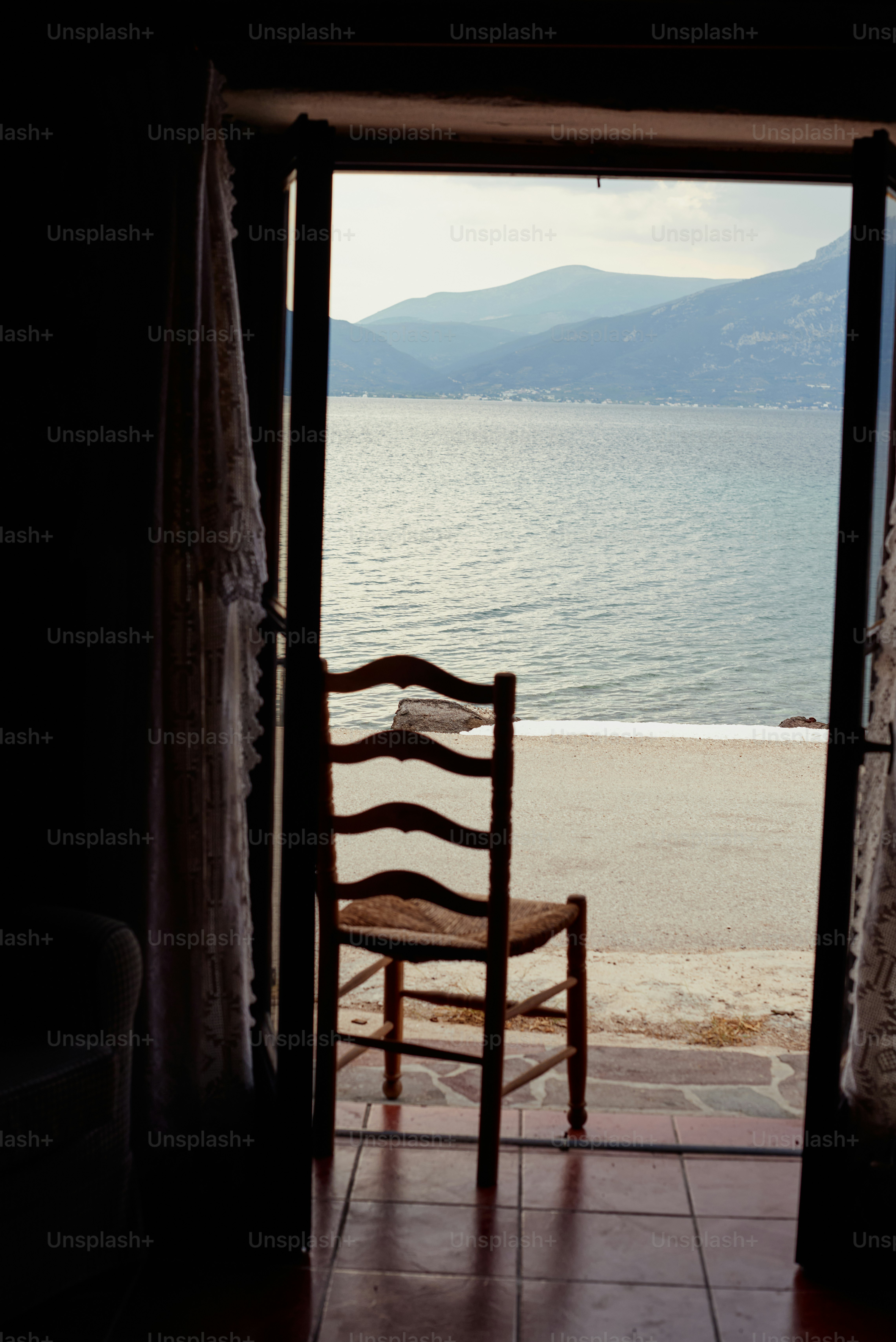 A chair sitting in front of an open door photo – Ugc Image on Unsplash