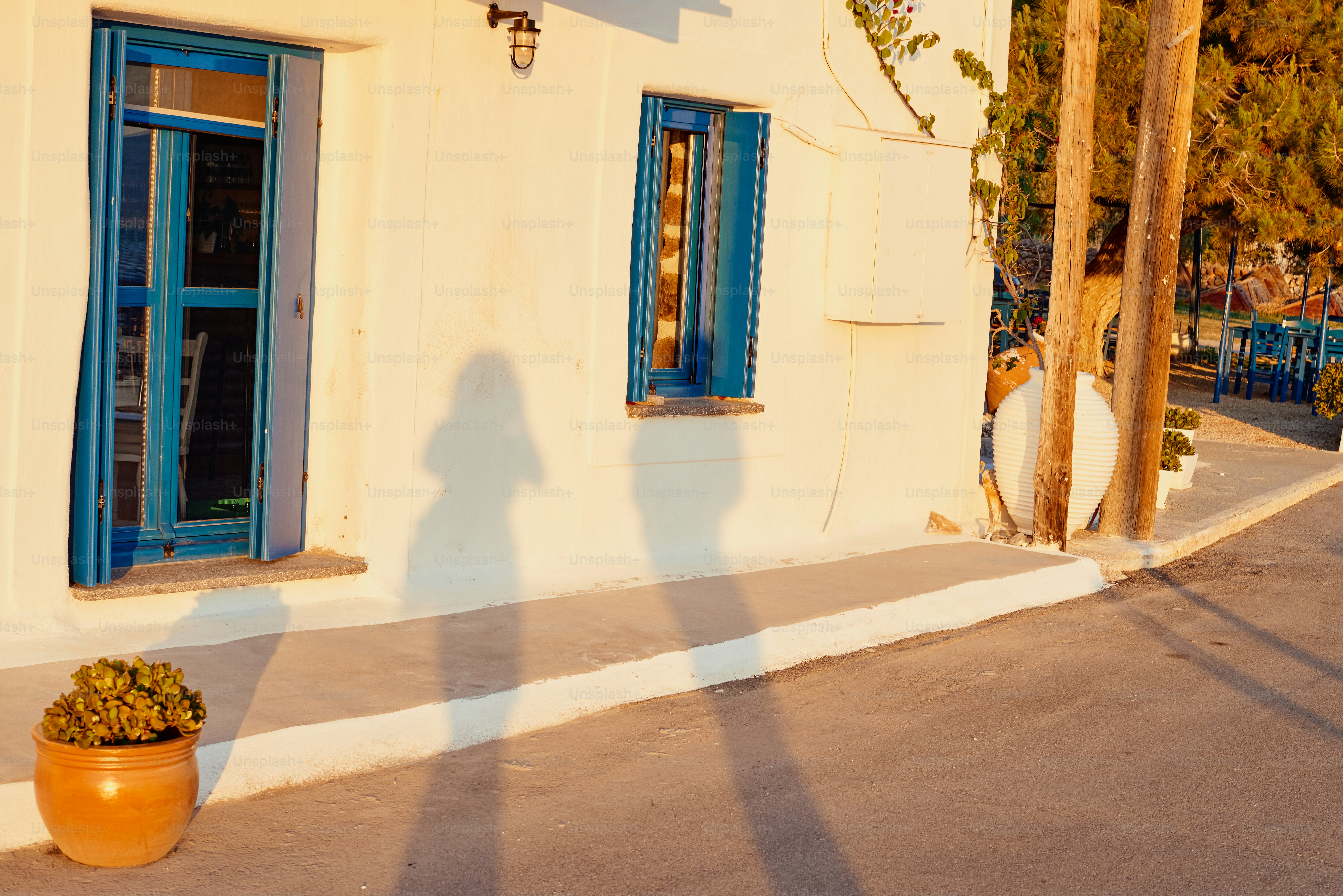 a shadow of a person standing in front of a building