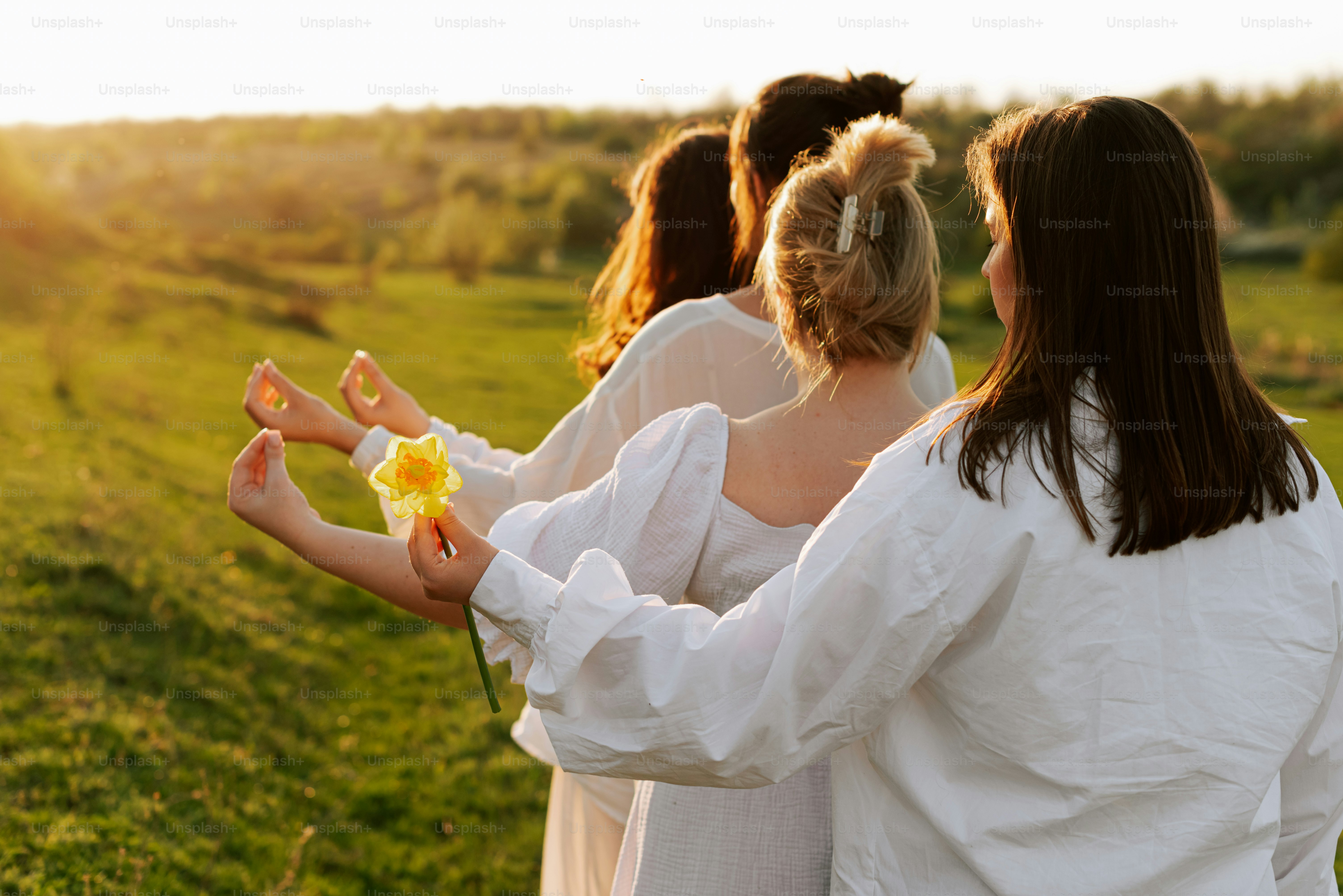 A group of women standing next to each other in a field photo – People ...