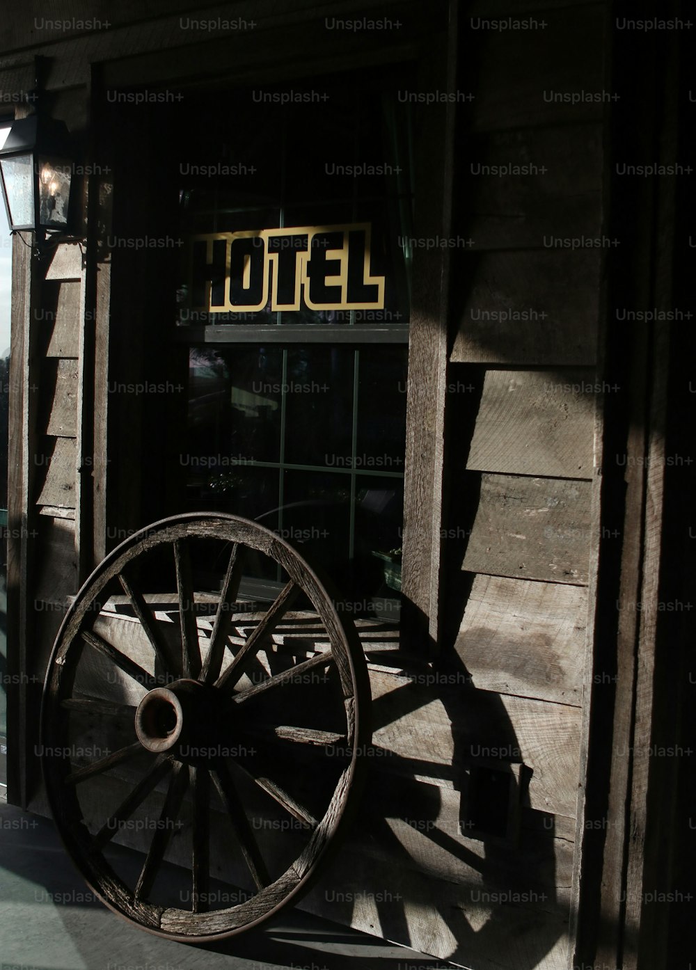 a large wooden wagon sitting in front of a hotel