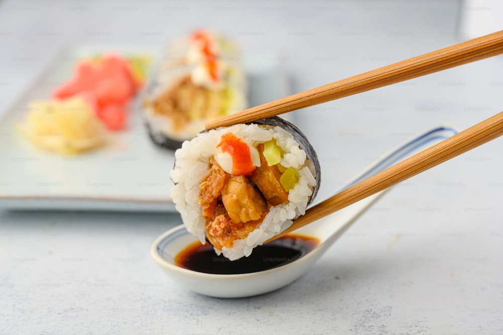 a plate of food with chopsticks sticking out of it