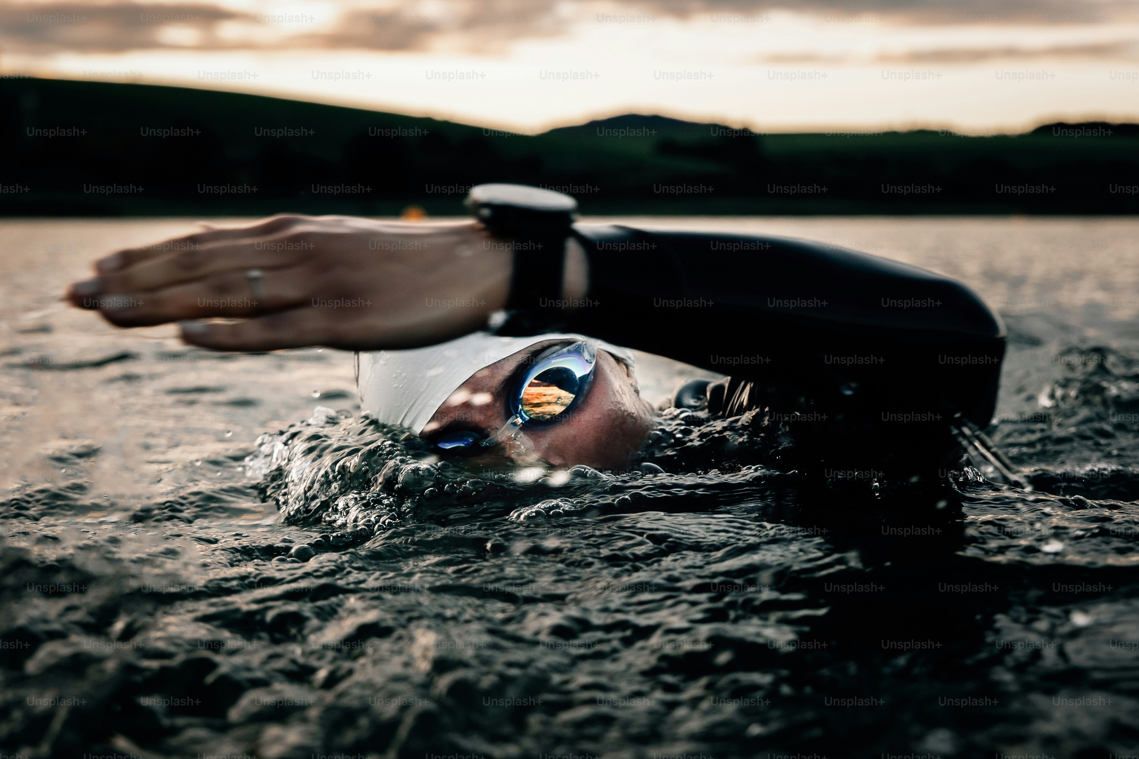a man in a wet suit swimming in the water