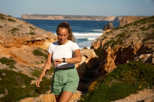 una mujer bajando una colina junto al océano