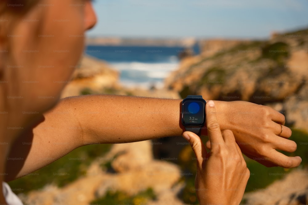 a close up of a person holding a smart watch