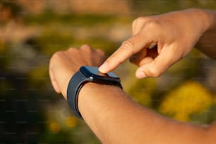 a person holding a smart watch in their hand