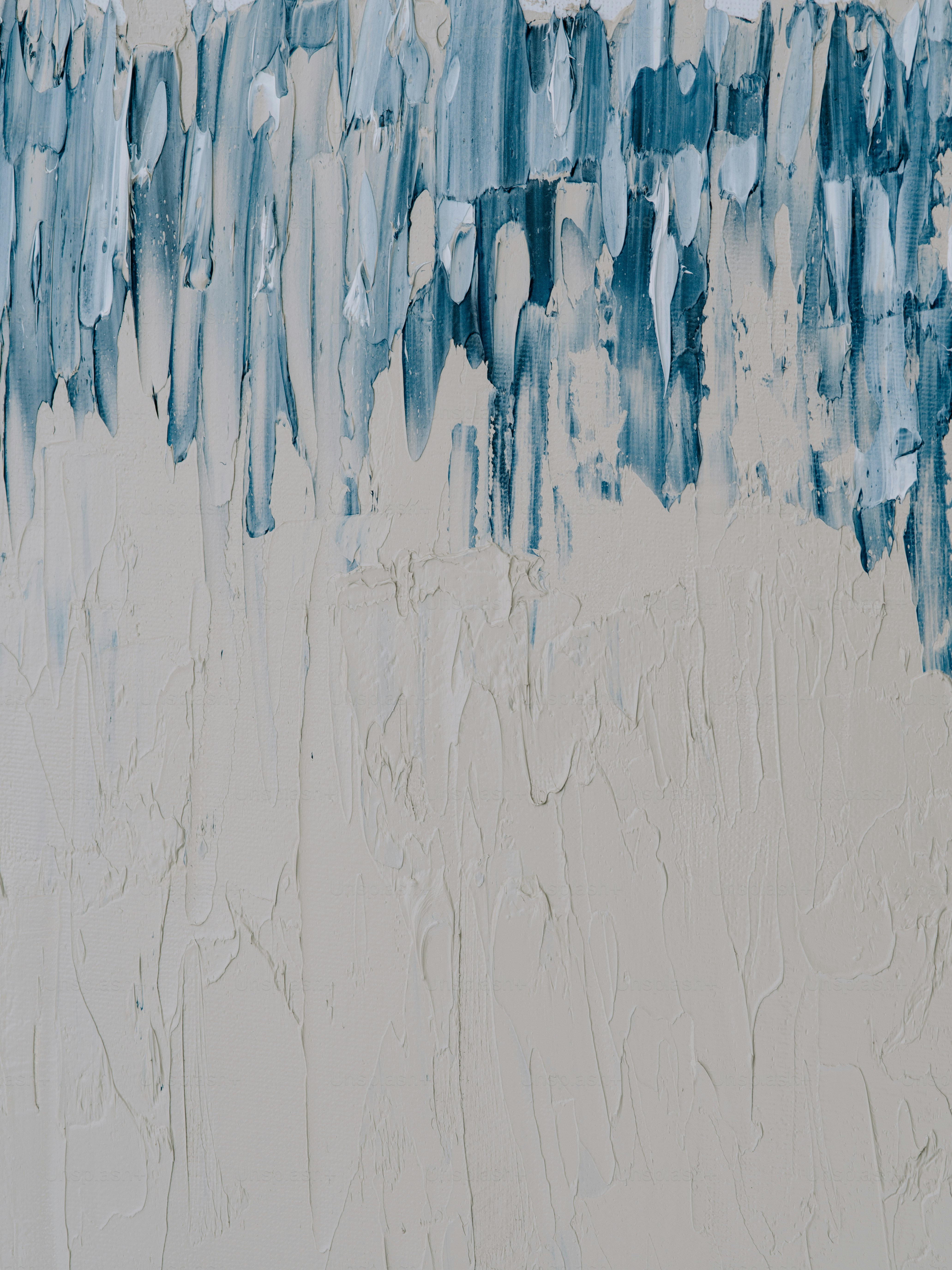 a painting of blue and white paint on a wall