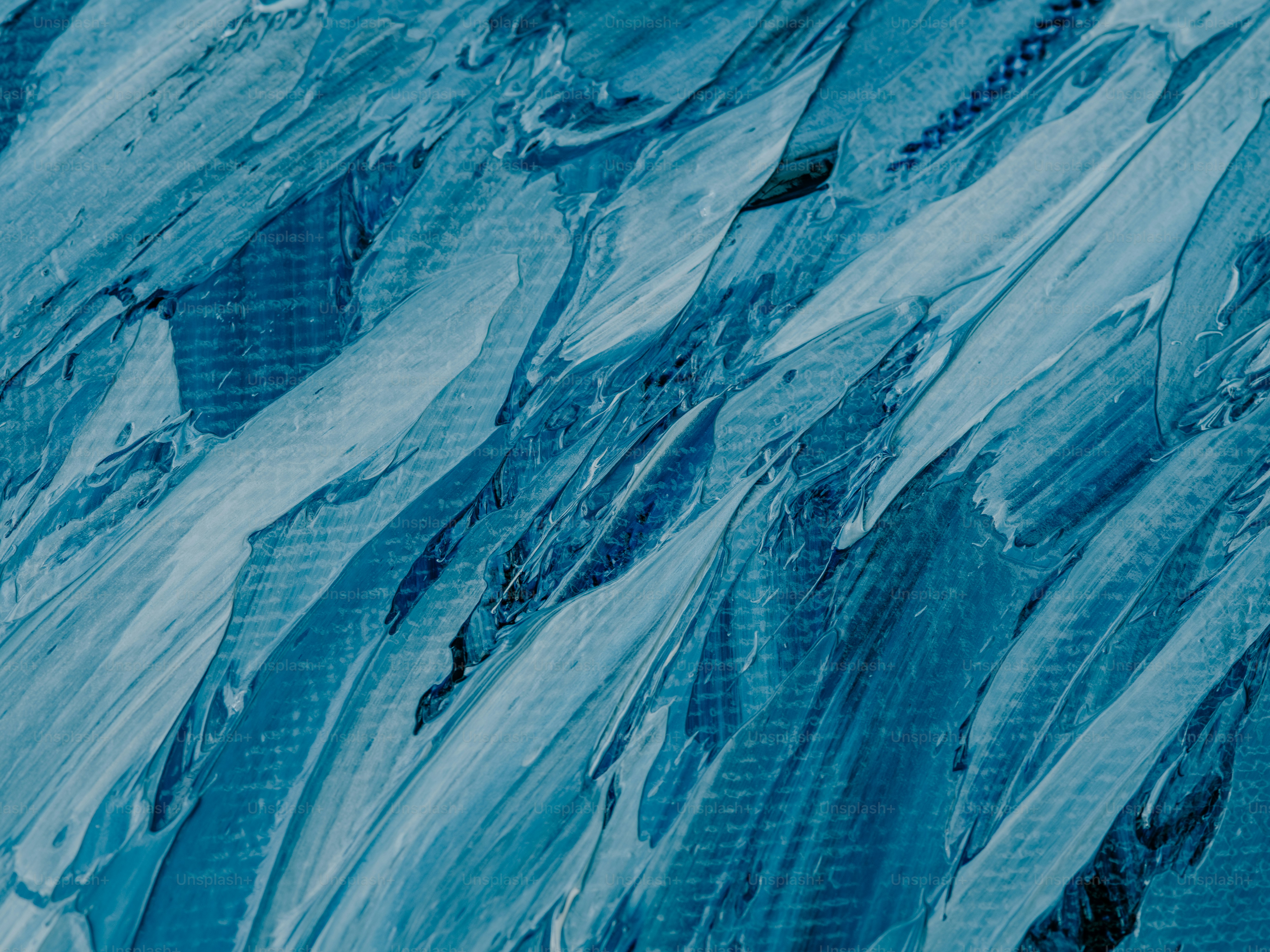 a snowboarder is going down a snowy hill