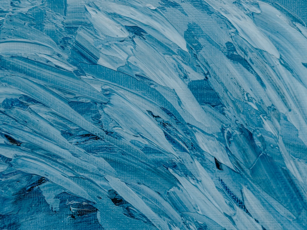 an abstract painting of blue and white paint