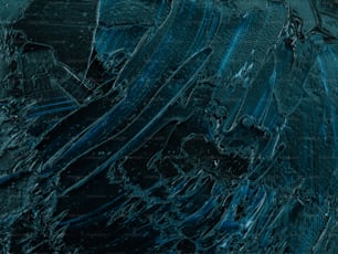 a close up of a black and blue abstract painting