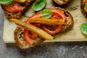 a wooden cutting board topped with slices of bread