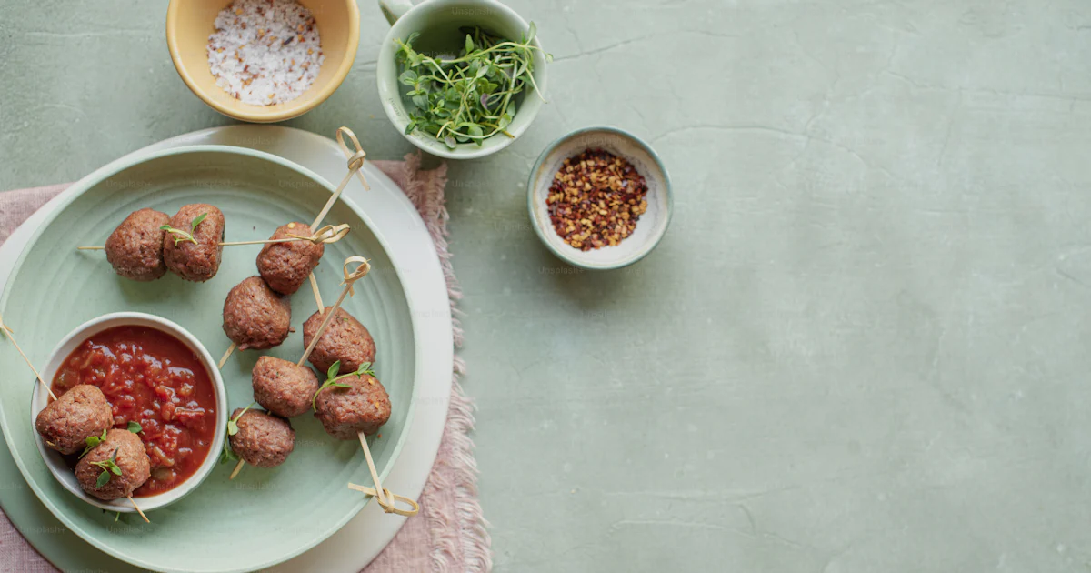 Meatball Splash A plate with meatballs and sauce on it photo β Vegan meatballs Image on ...