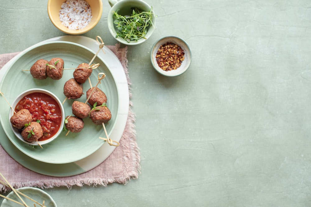 a plate with meatballs and sauce on it