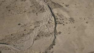 an aerial view of a dirt road in the desert