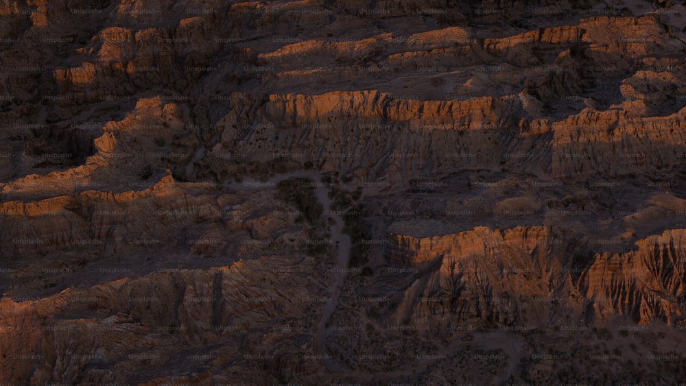 an aerial view of a rocky landscape at sunset