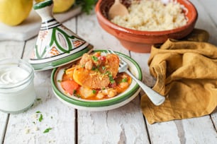 a bowl of stew next to a bowl of rice